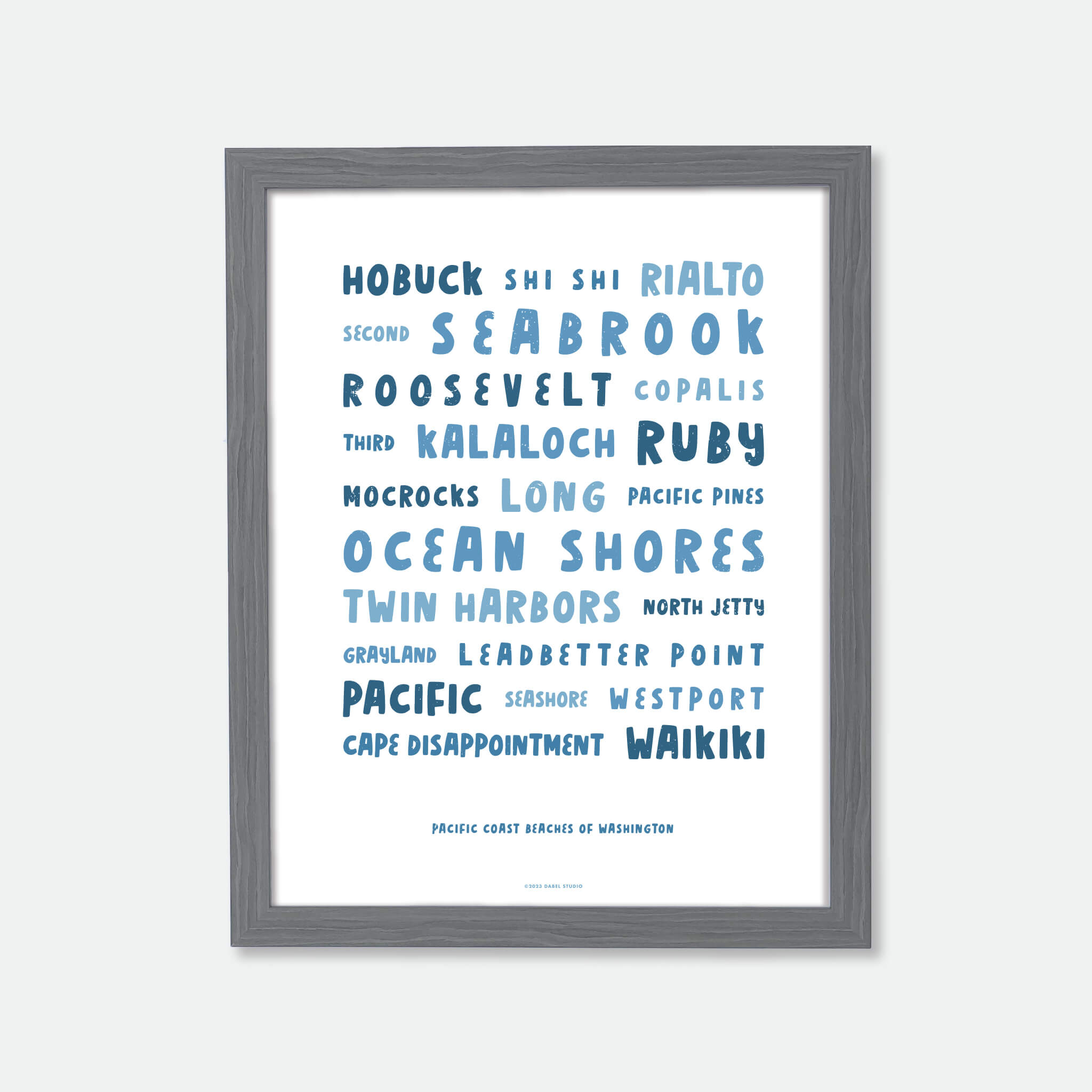 List of Washington beaches in fun font in blue on white in wood frame