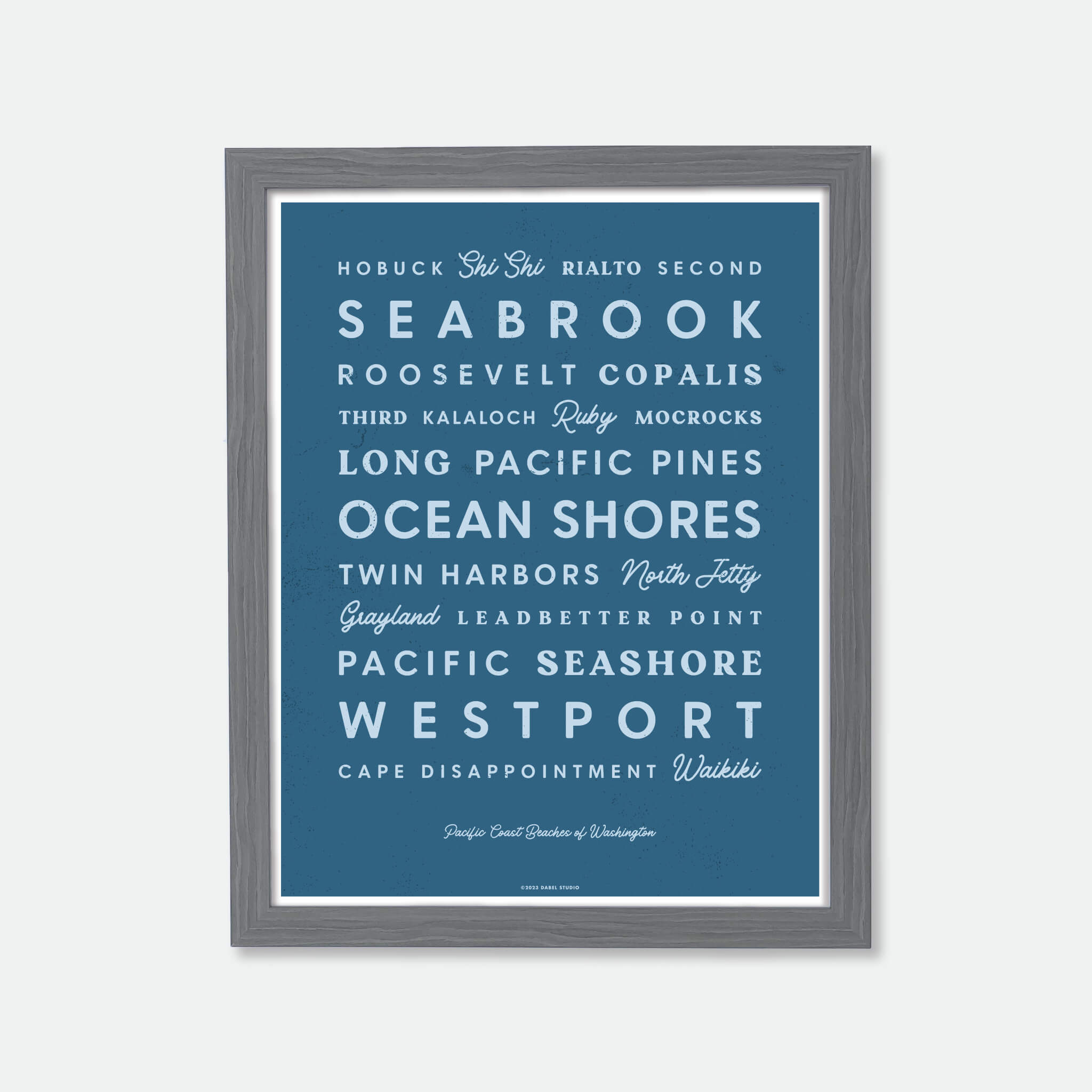 List of Washington beaches in retro fonts in blue on dark blue in wood frame