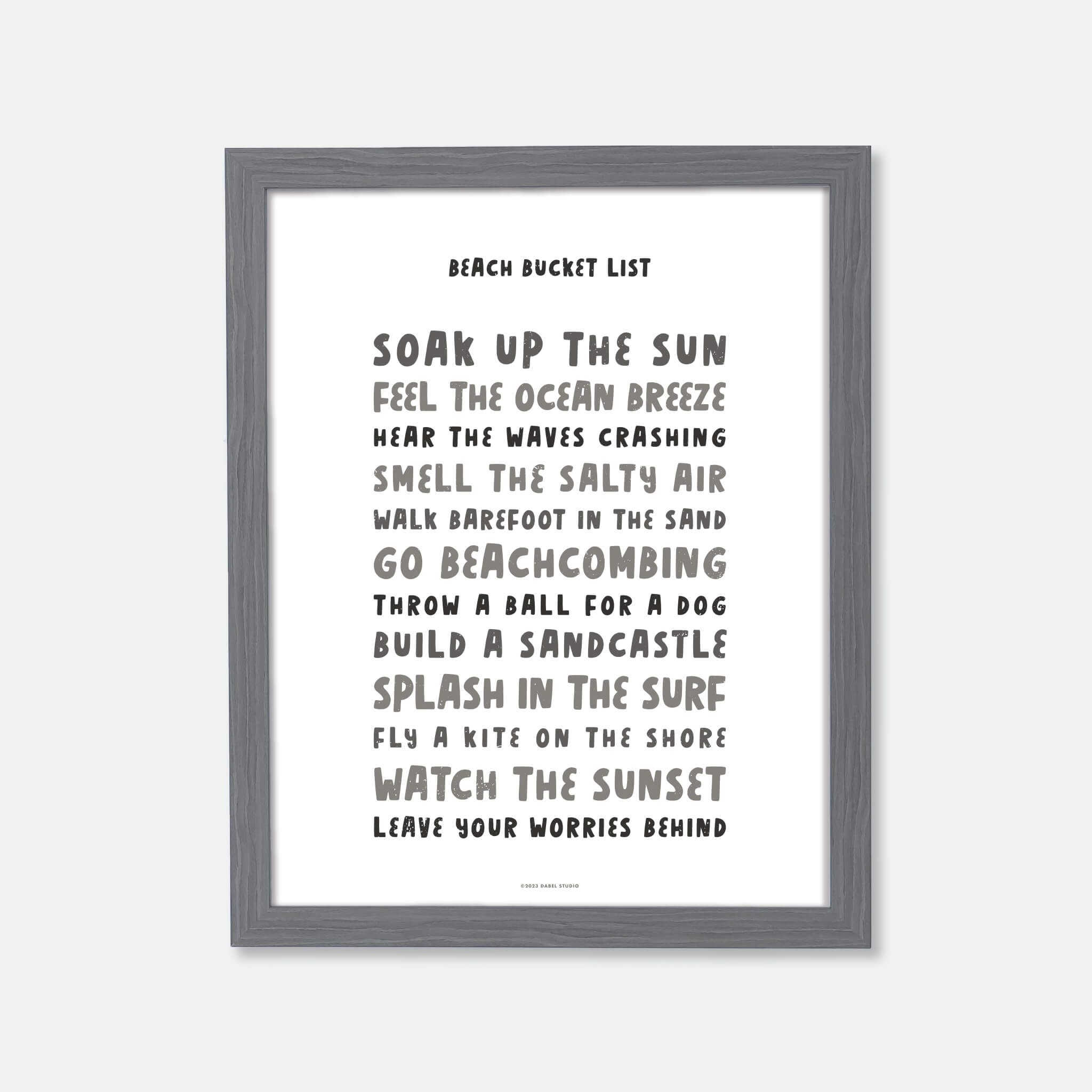 List of things to do at the beach in fun fonts in black on white in wood frame