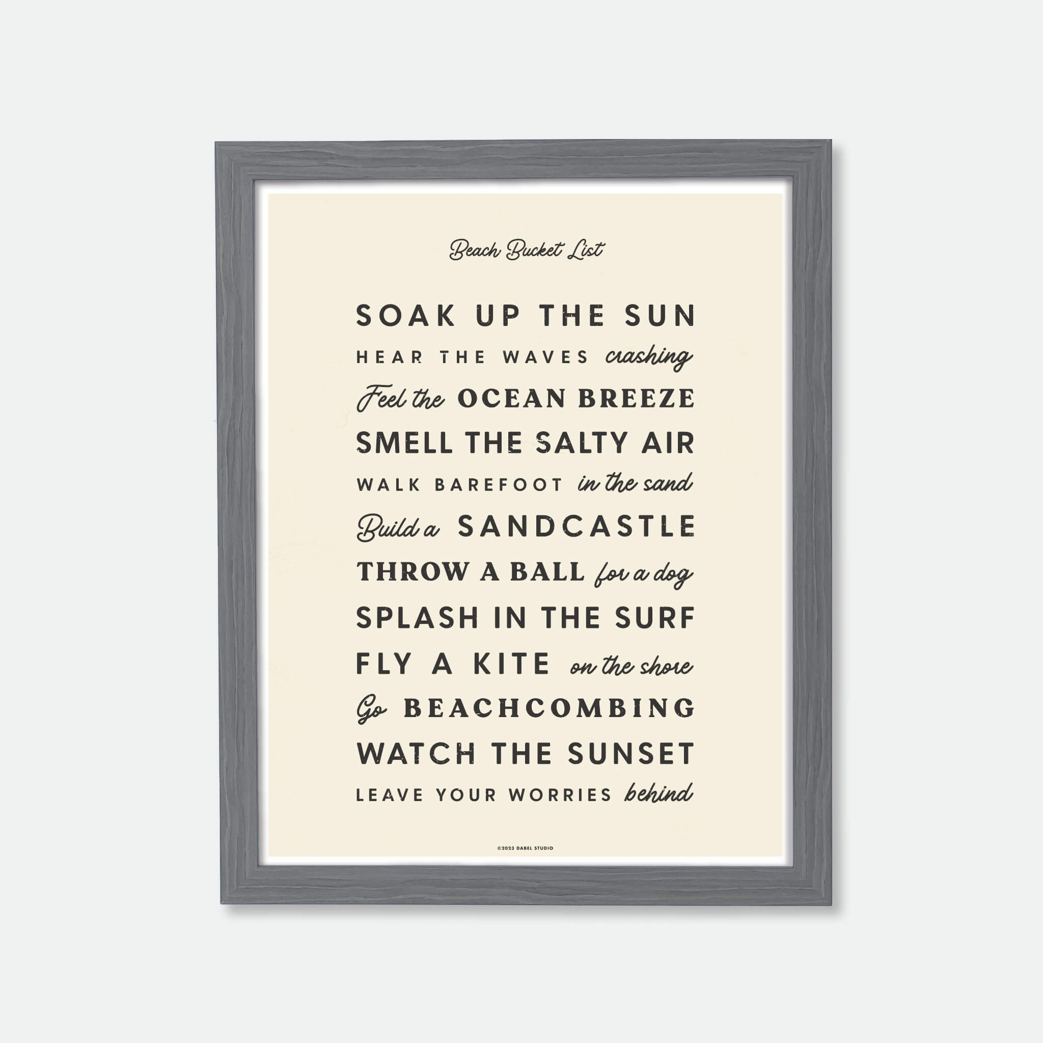 List of things to do at the beach in retro fonts in black on cream in wood frame